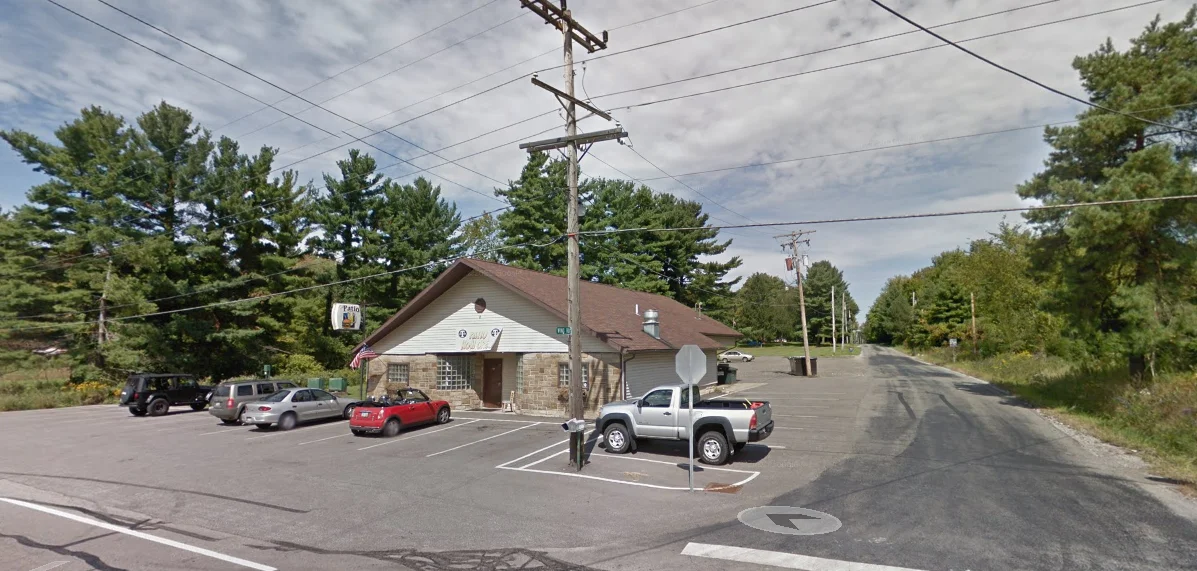 Charming restaurant exterior with parking and trees