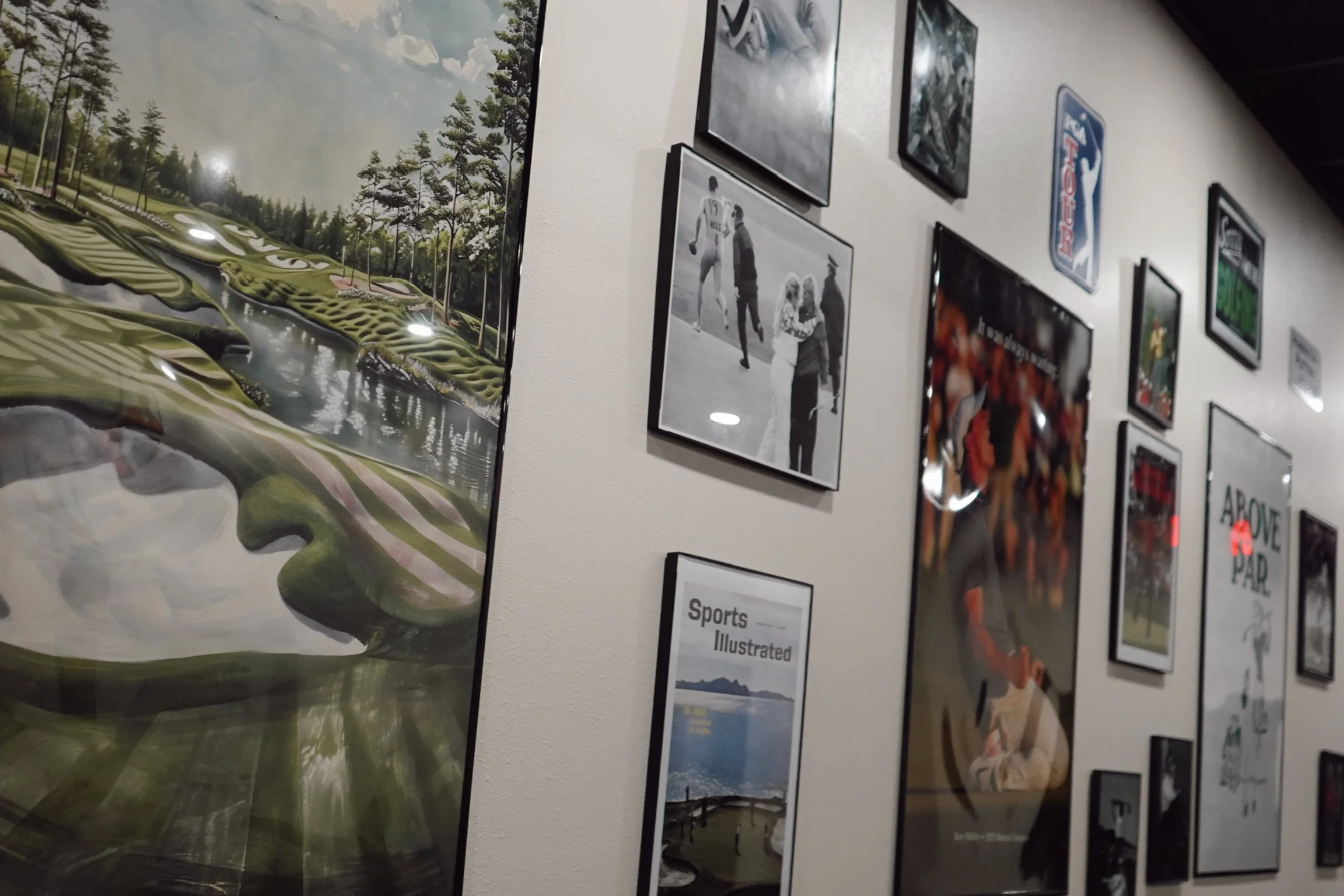 Gallery wall featuring golf-themed art and memorabilia
