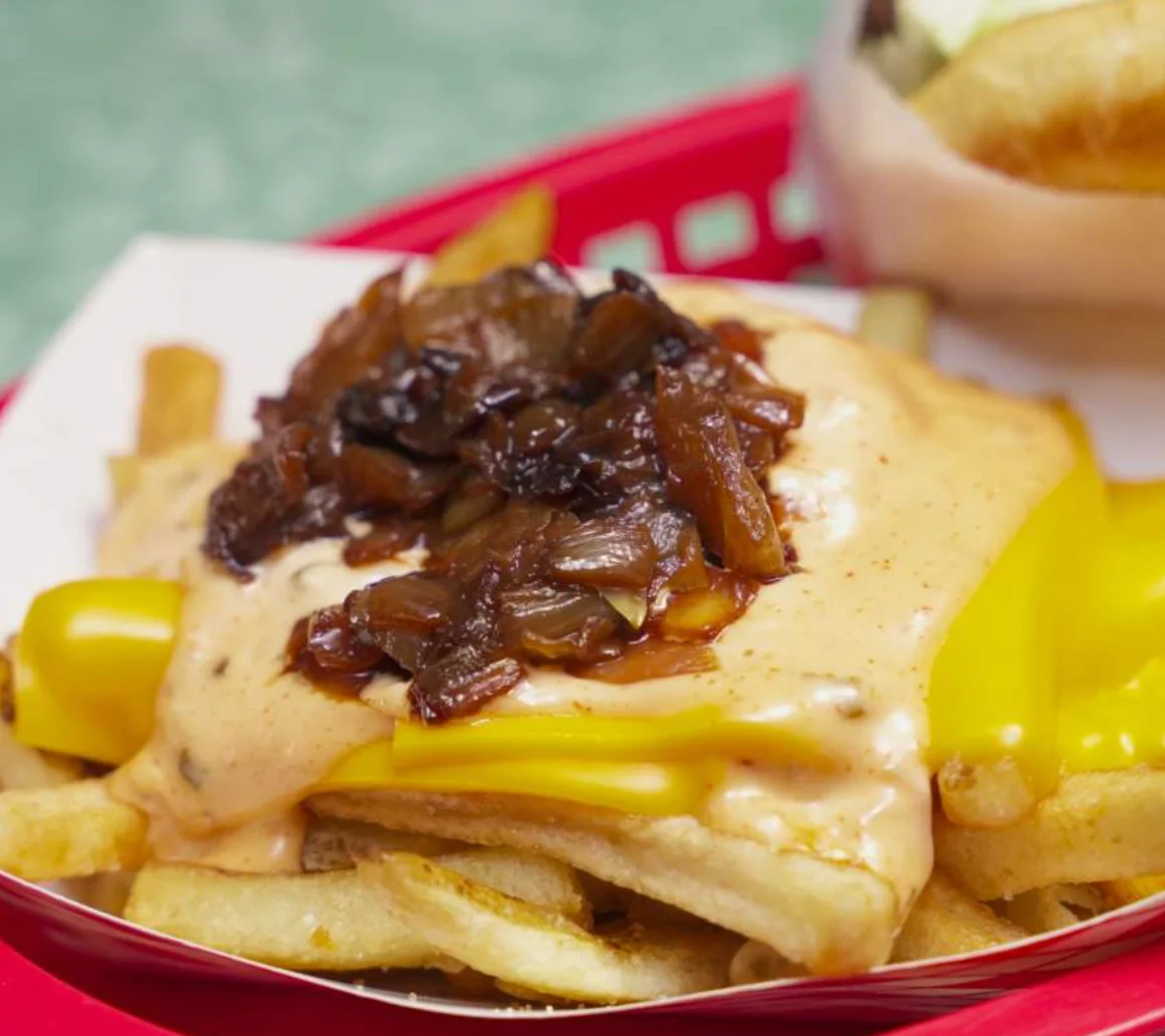 Two Hayes Burger cheeseburgers and fries on a checkered tray at the Normal Heights shop on Adams Ave