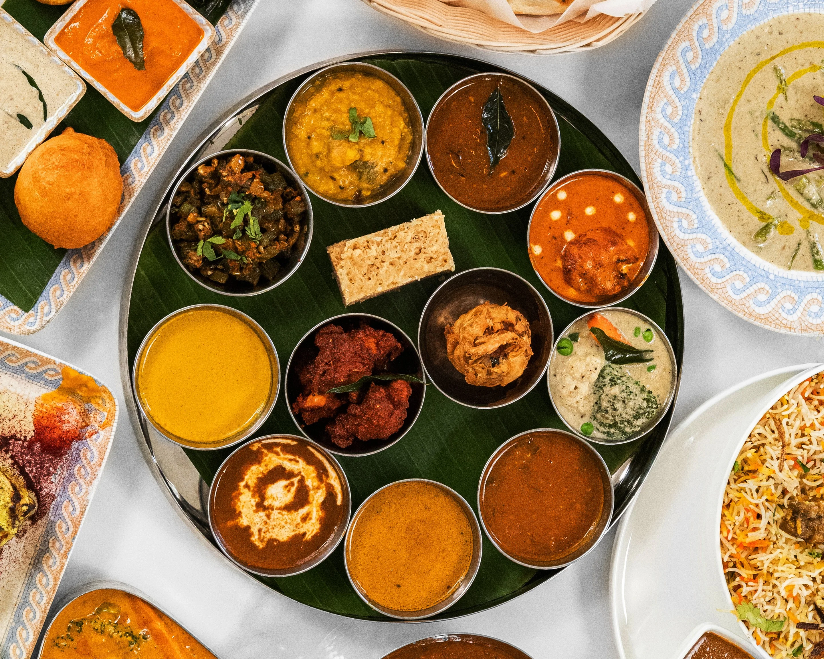 Assorted South Indian thali with curries and rice dishes