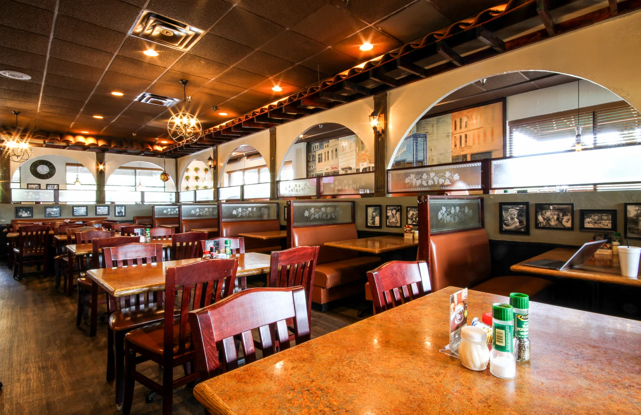 Interior of a cozy restaurant with wooden tables and booths.