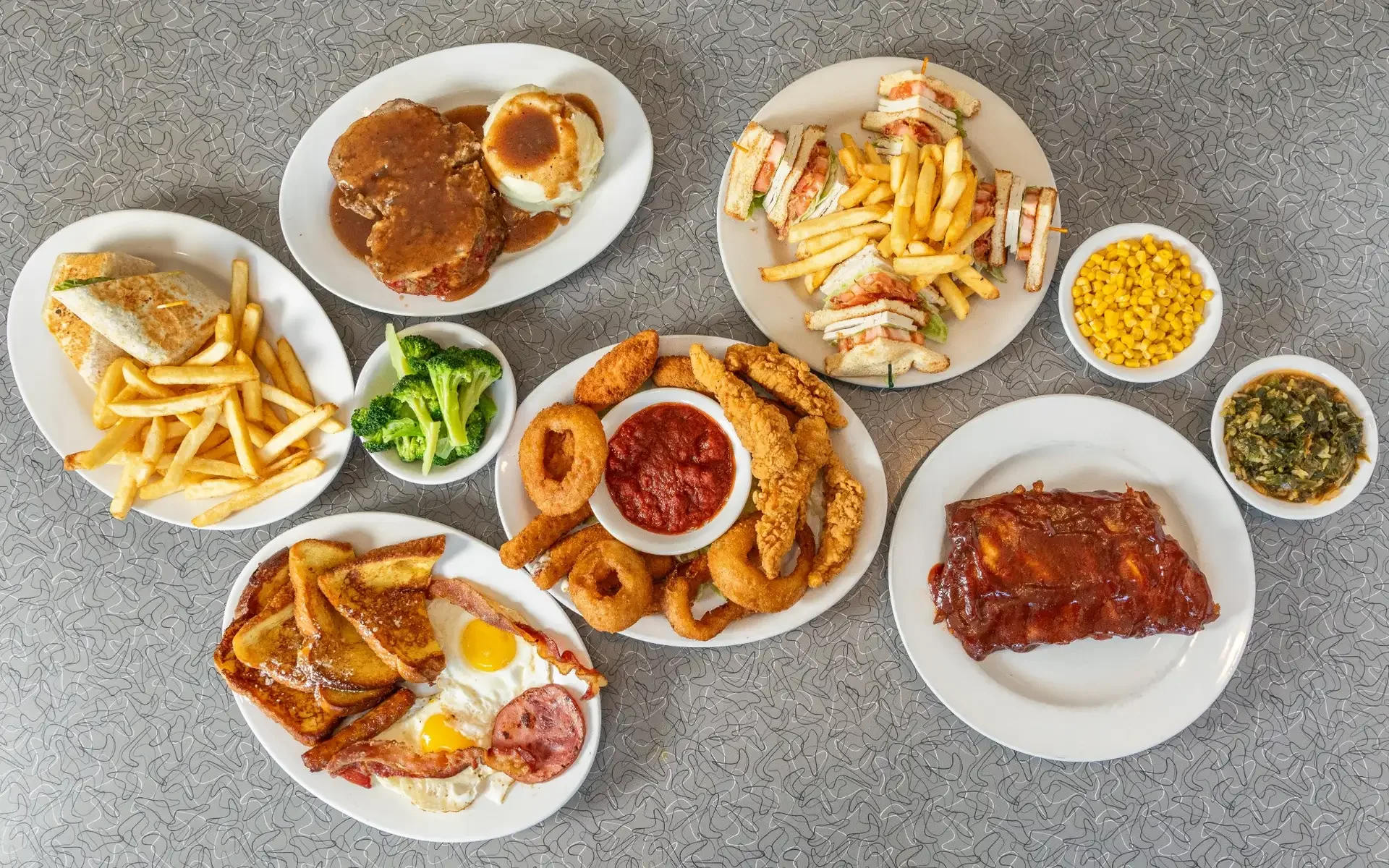 Southern breakfast platter with waffles, grits, and fried chicken