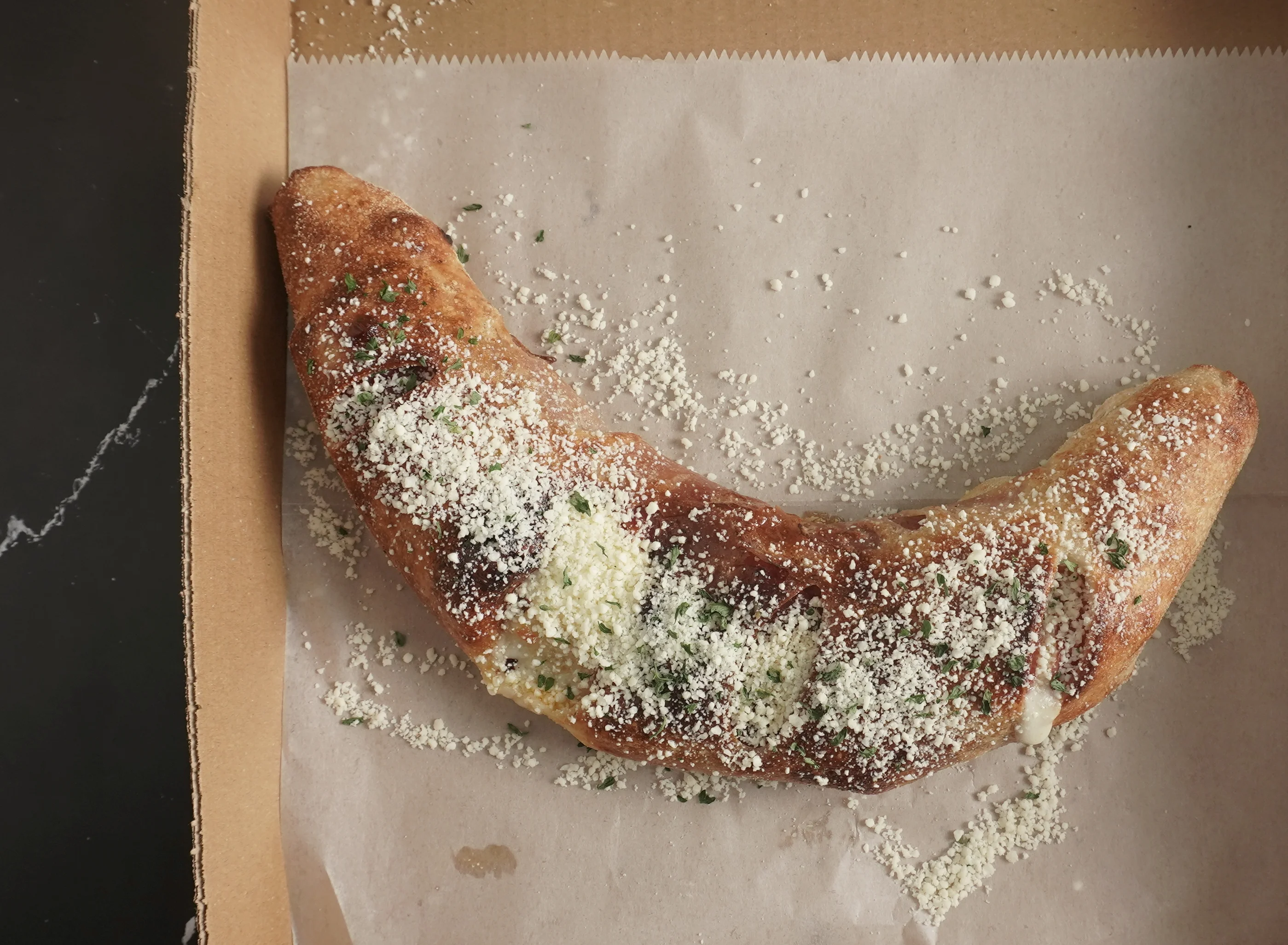 A Stromboli with Mozzarella, Salami, and Pepperoni rolled in fresh dough and baked until Golden crispy.