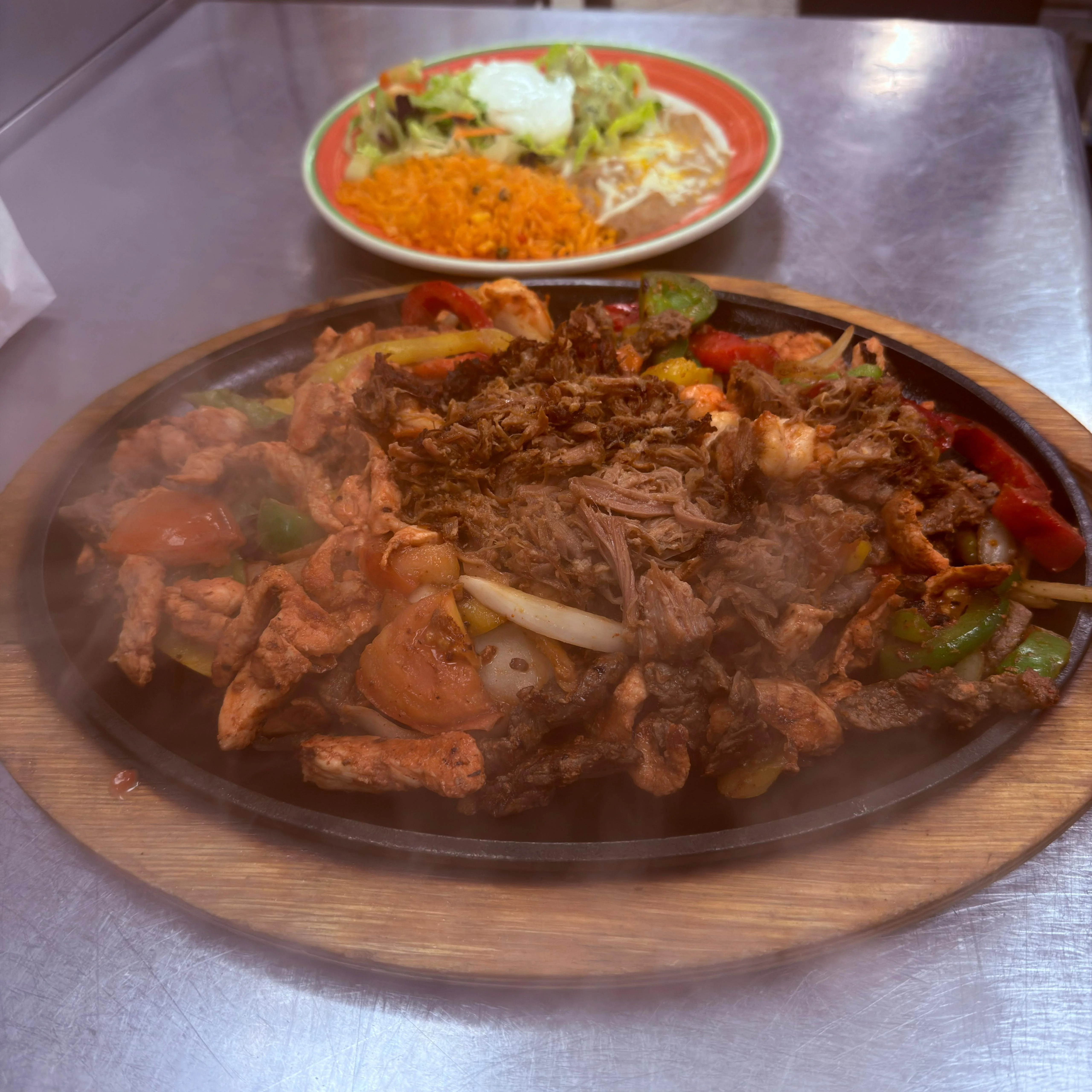 Delicious gourmet burger with fresh toppings on a wooden table.