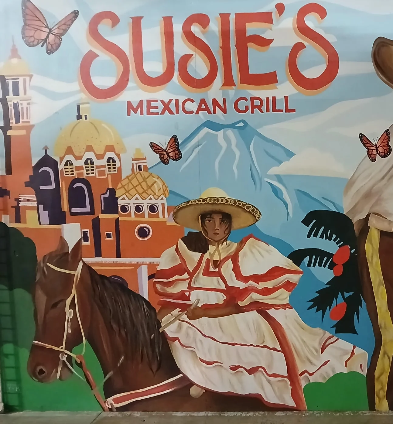Colorful mural at Susie's Mexican Grill featuring traditional Mexican culture