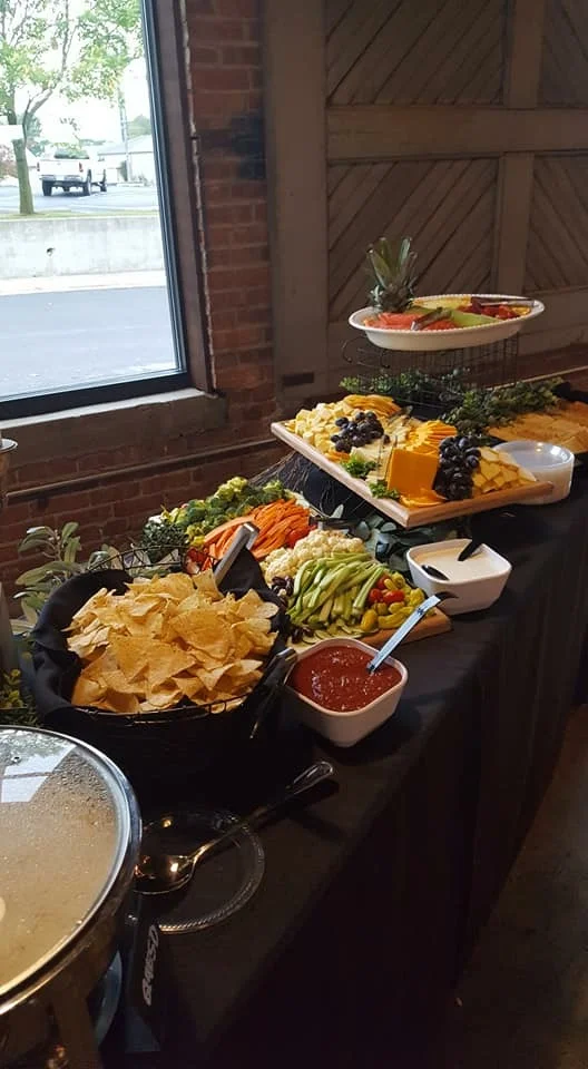 Colorful appetizer spread with chips and fresh vegetables