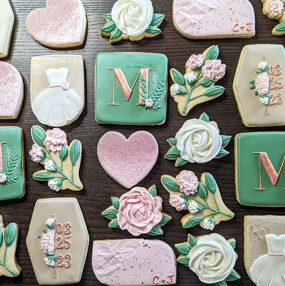 Decorative wedding cookies with floral designs and initials