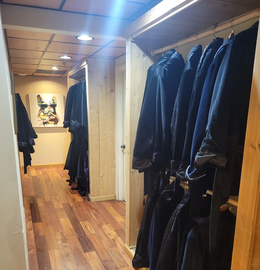 Cozy lounge area with leather seating and lockers in a stylish setting.