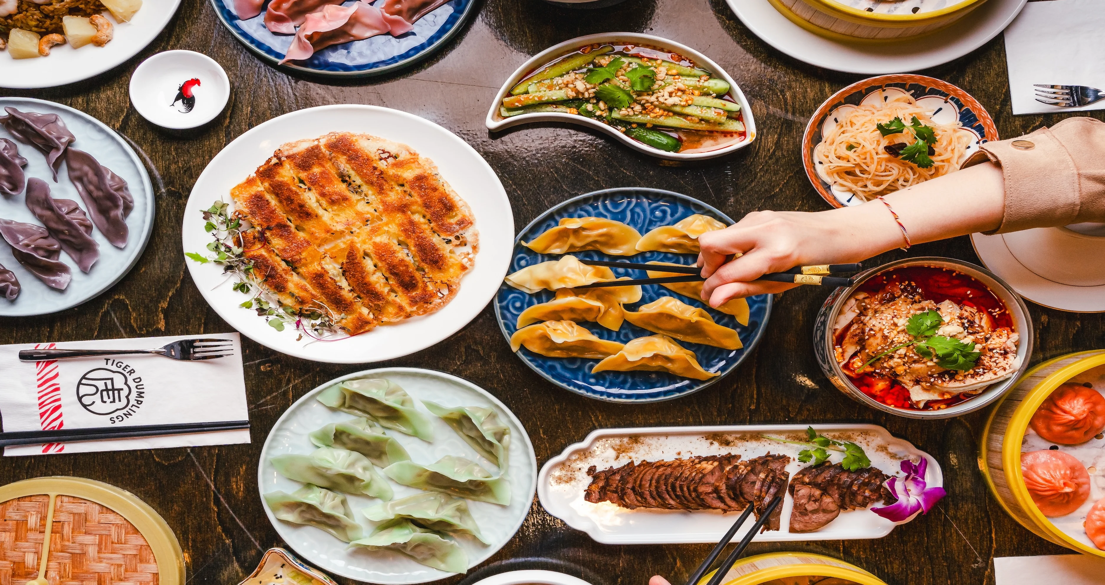 Assorted Chinese dumplings and dishes on a wooden table