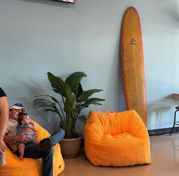 Cozy restaurant seating area with bean bags and surfboard decor