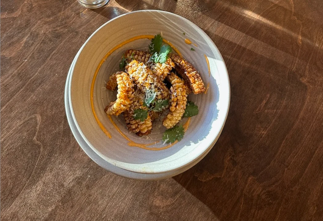 Grilled Mexican street corn with cilantro and sauce