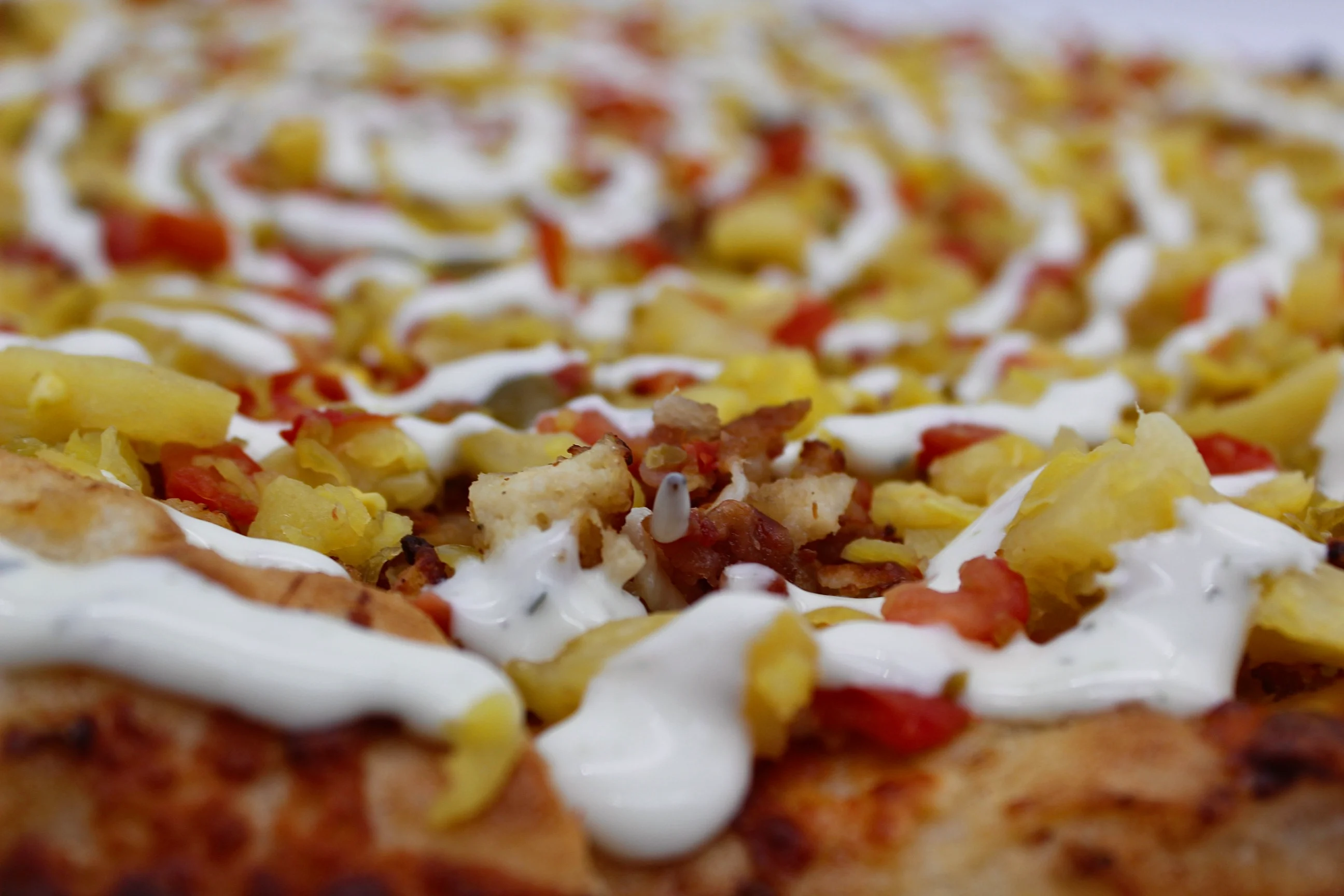 Delicious pizza topped with savory ingredients and drizzled with sauce