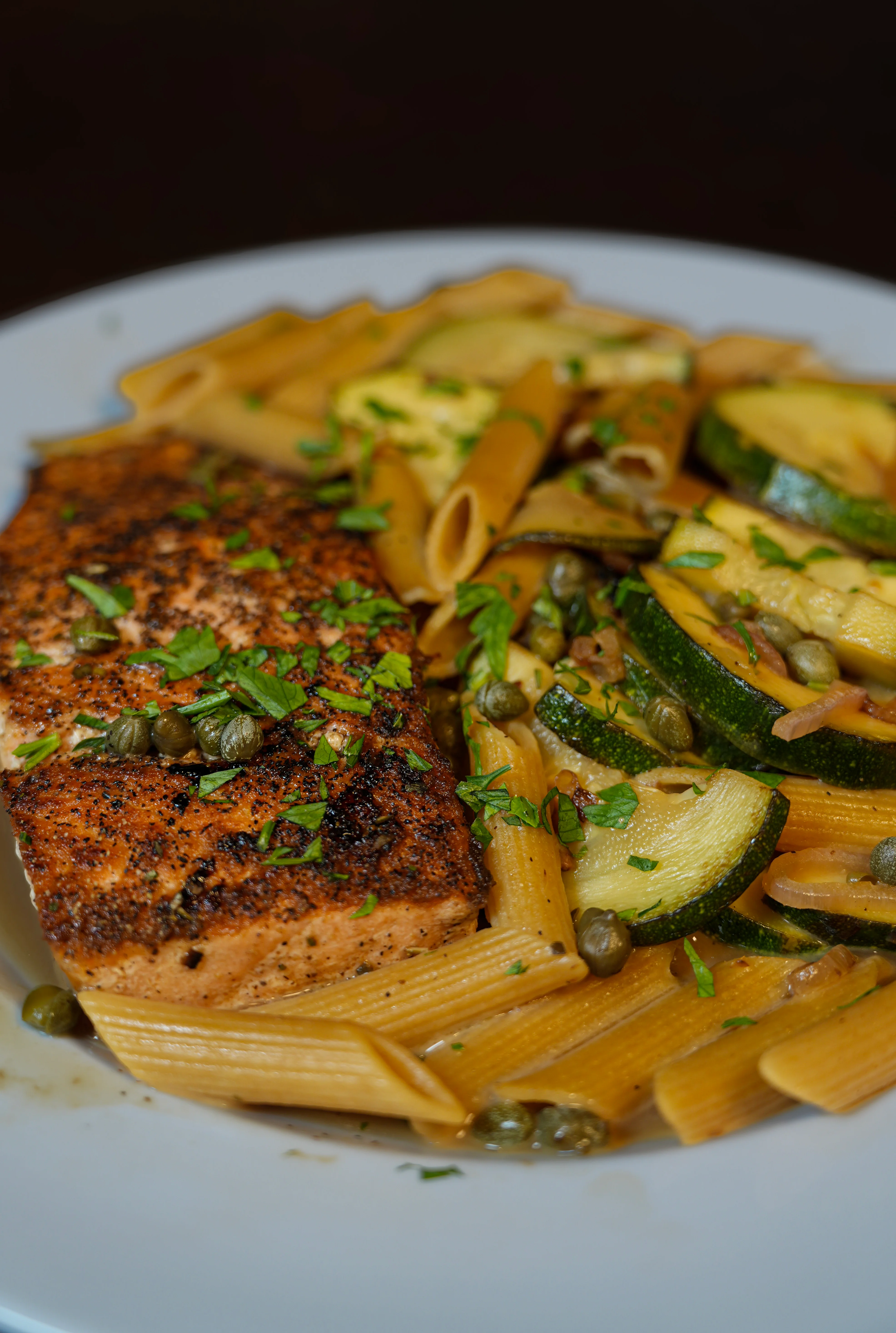 Grilled salmon with whole wheat pasta and zucchini, Mediterranean style