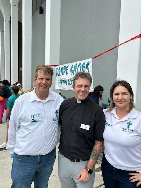 A group of volunteers posing for a photo at a community event, promoting a charitable cause.