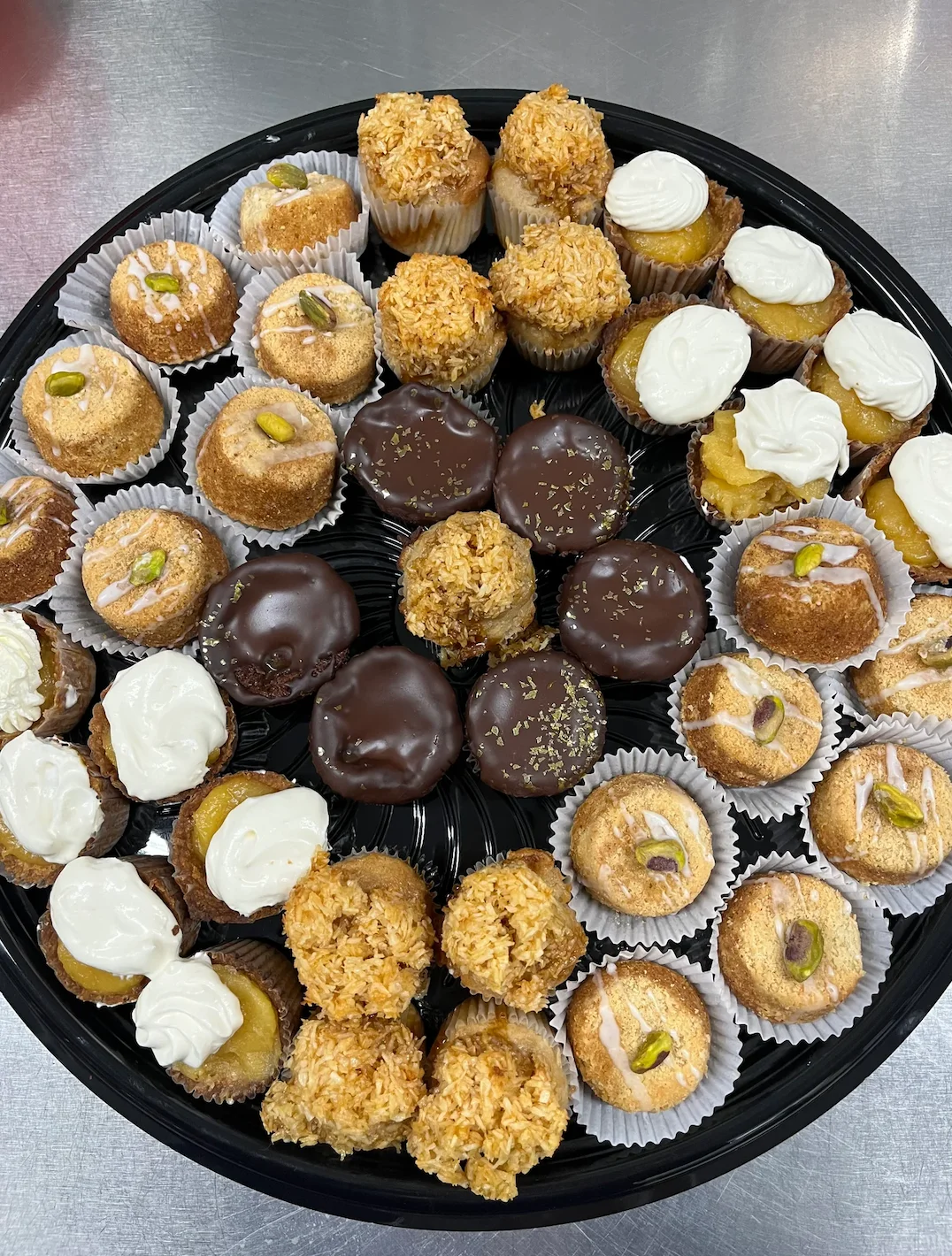 Assorted Middle Eastern mini desserts on a black platter