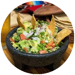 Fresh guacamole served in a traditional molcajete