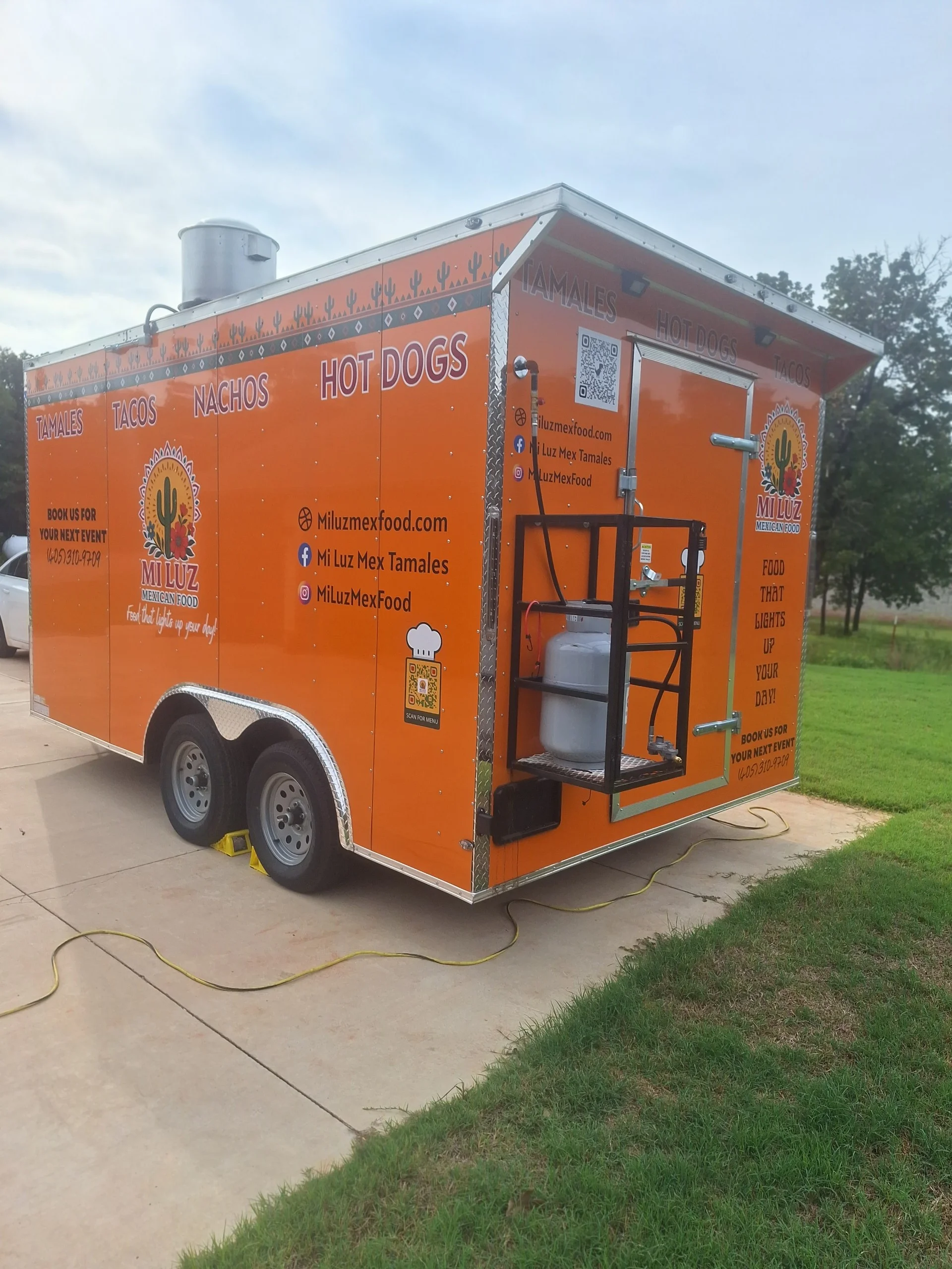 Colorful food truck offering Mexican tamales and tacos