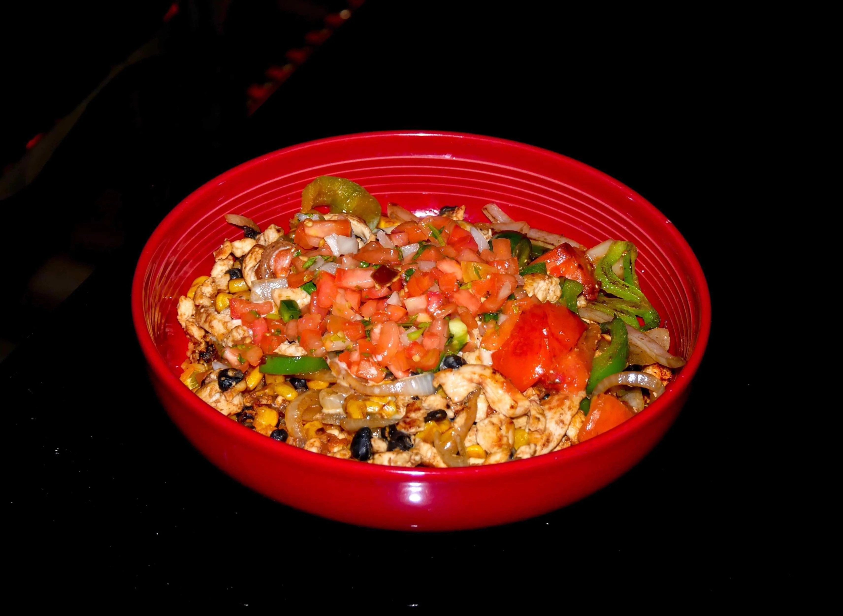 Colorful Mexican chicken fajita bowl with fresh pico de gallo