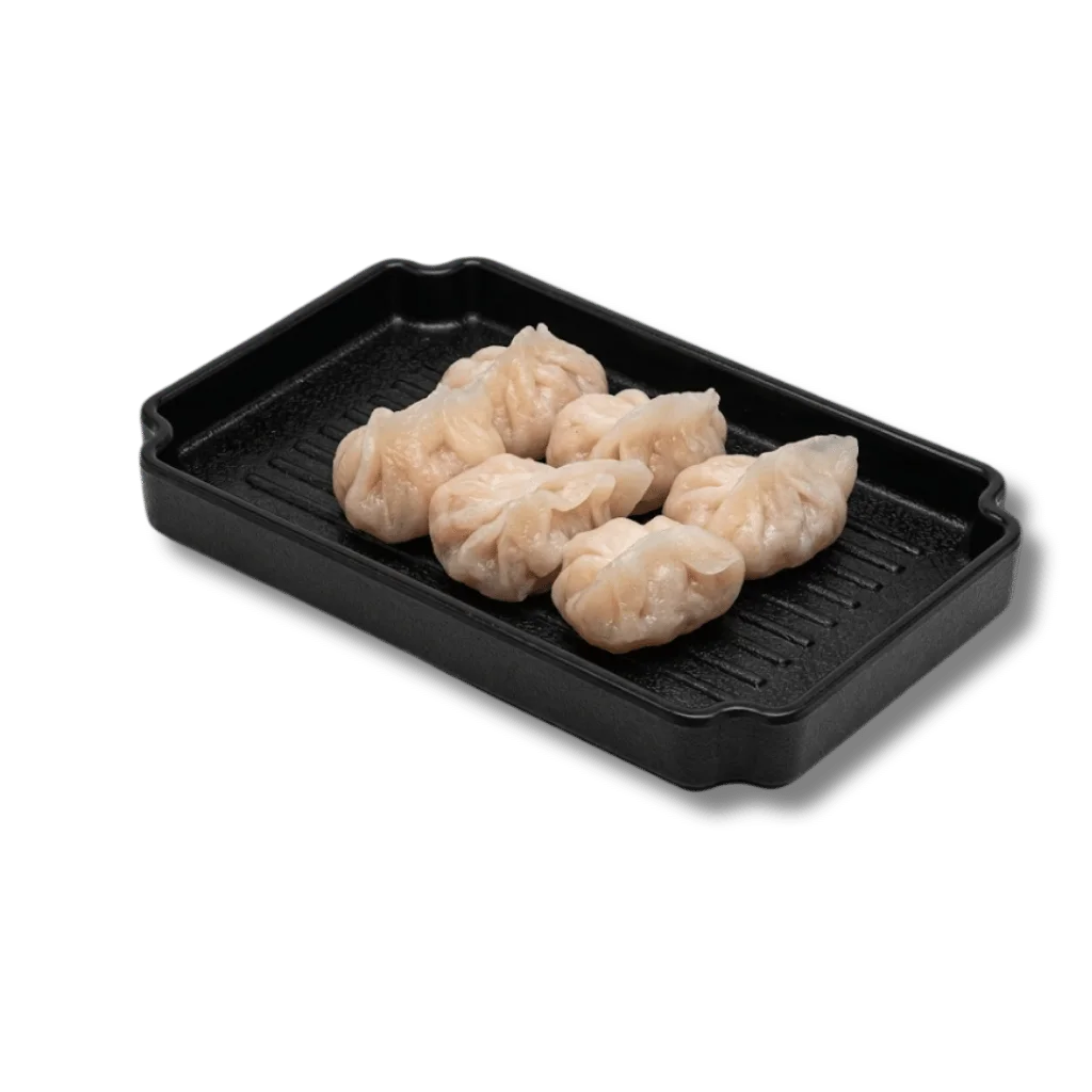 A plate of six dumplings on a black serving tray.