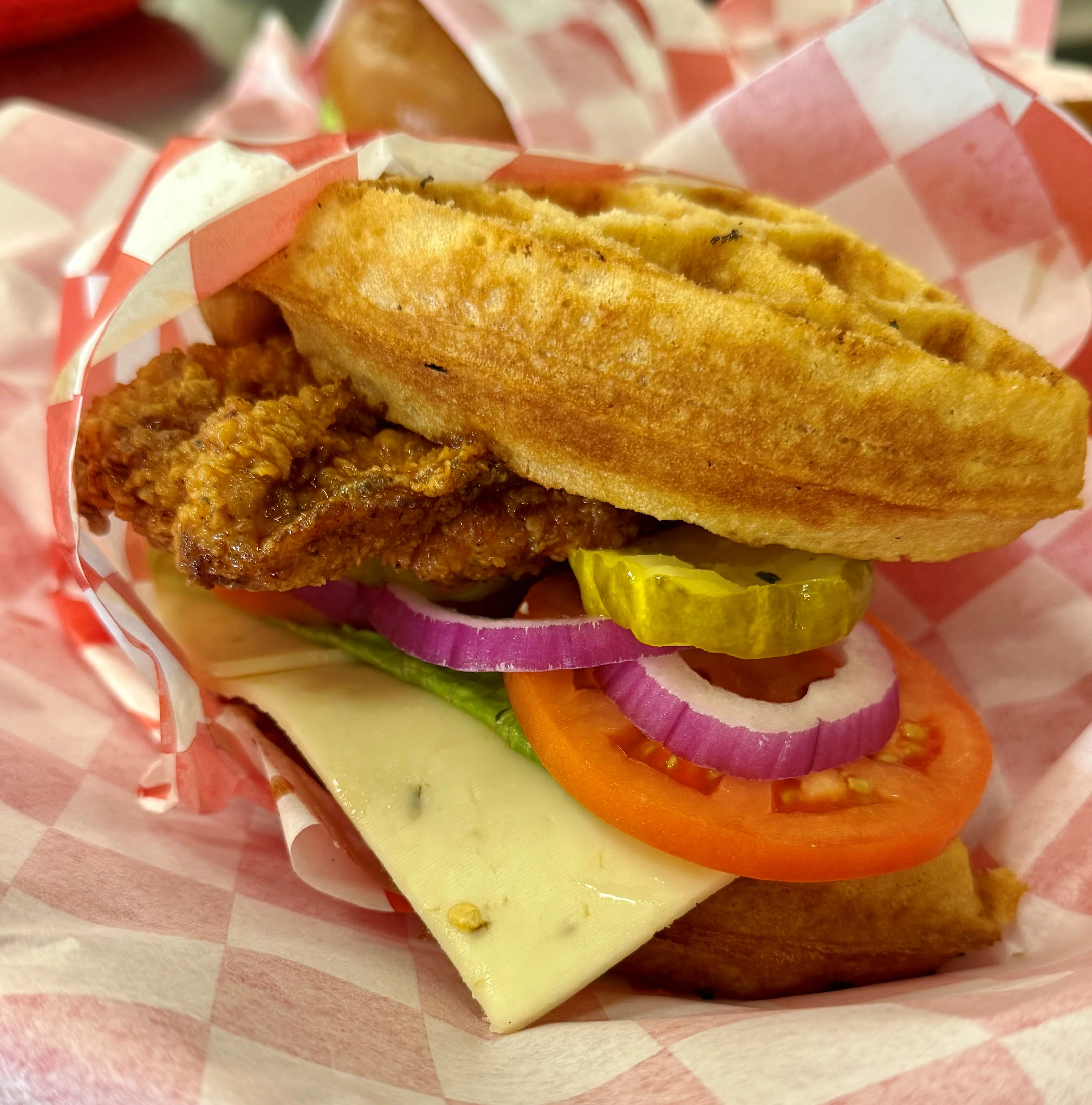Southern chicken and waffle sandwich with fresh toppings