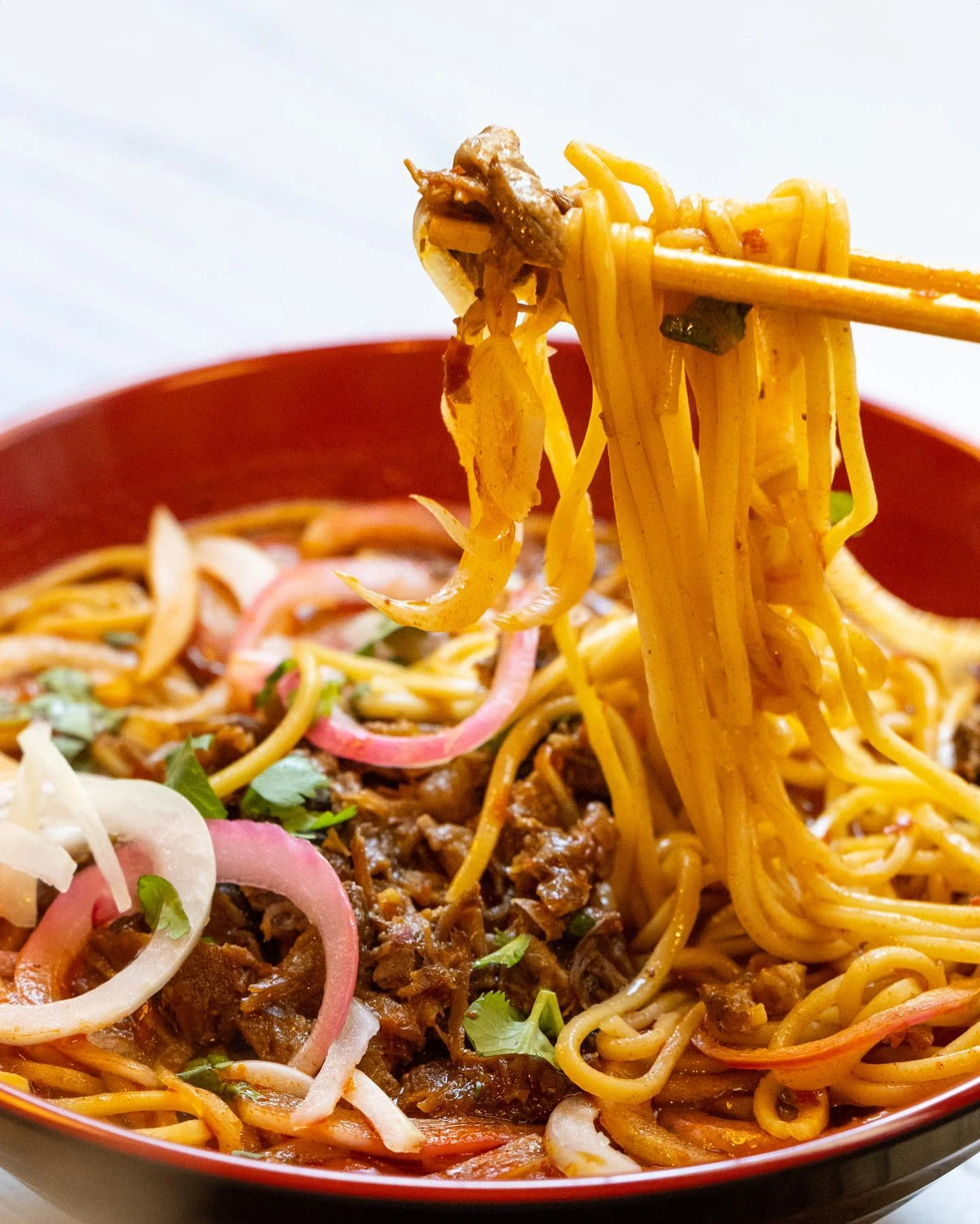 Spicy beef chow mein with colorful vegetables