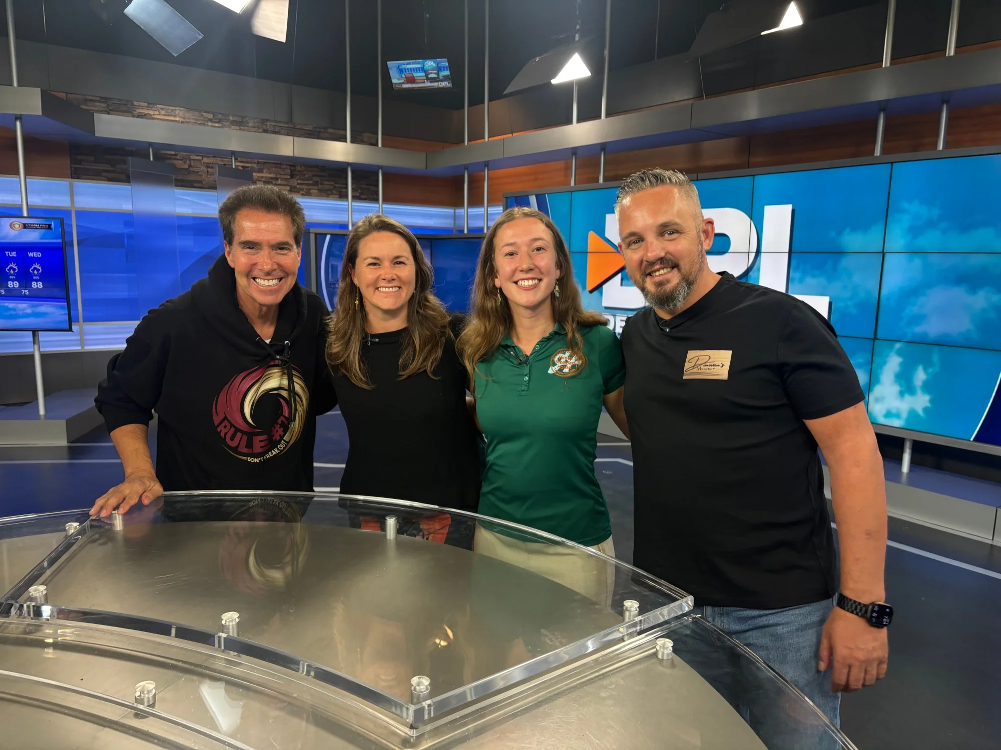 Restaurant team smiling together on a television studio set