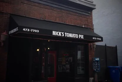 Exterior of Nick's Tomato Pie restaurant with awning