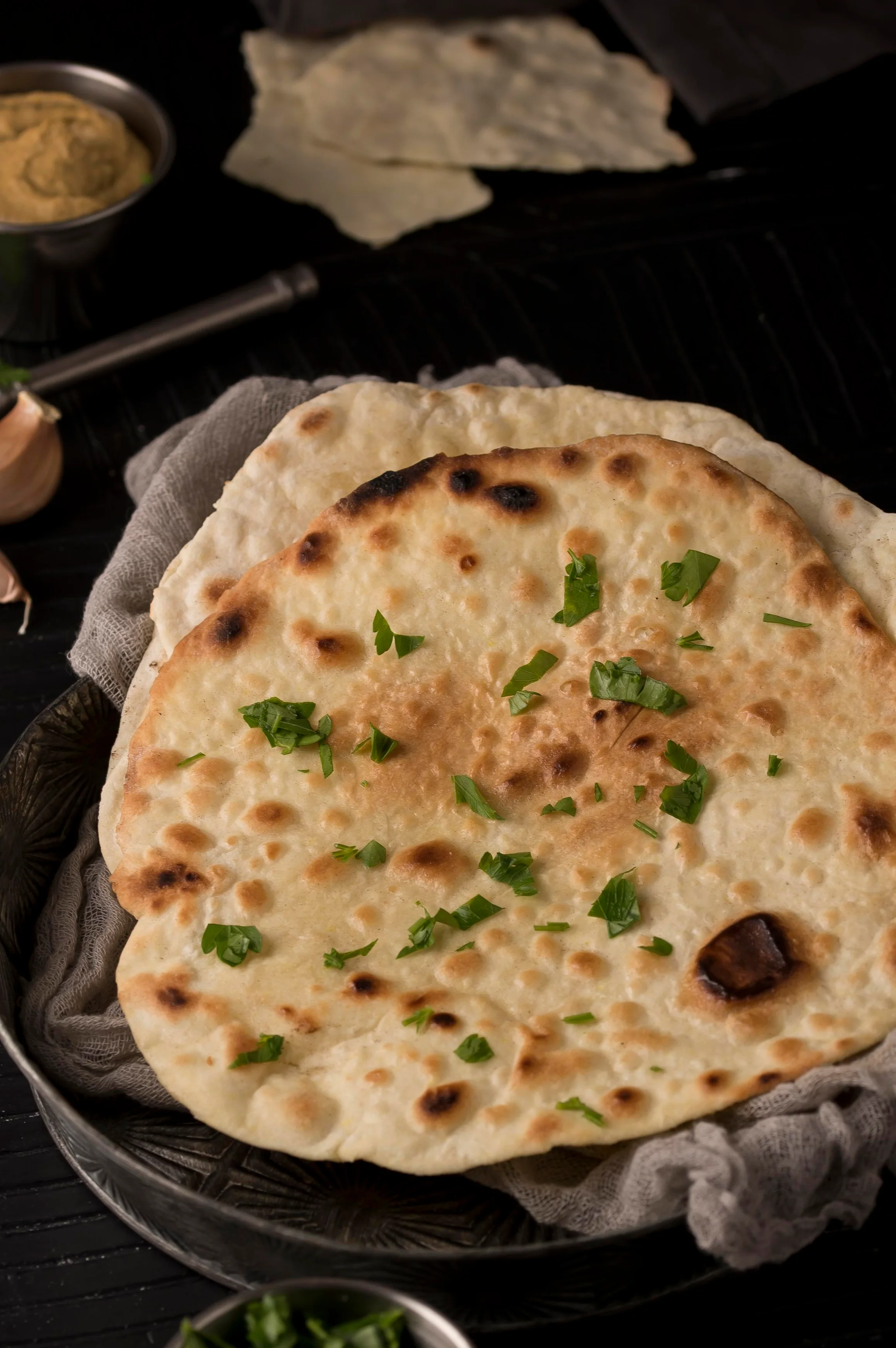 Freshly baked Indian naan bread with herbs