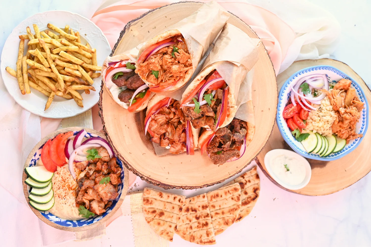 Assorted Middle Eastern wraps with fries and dips