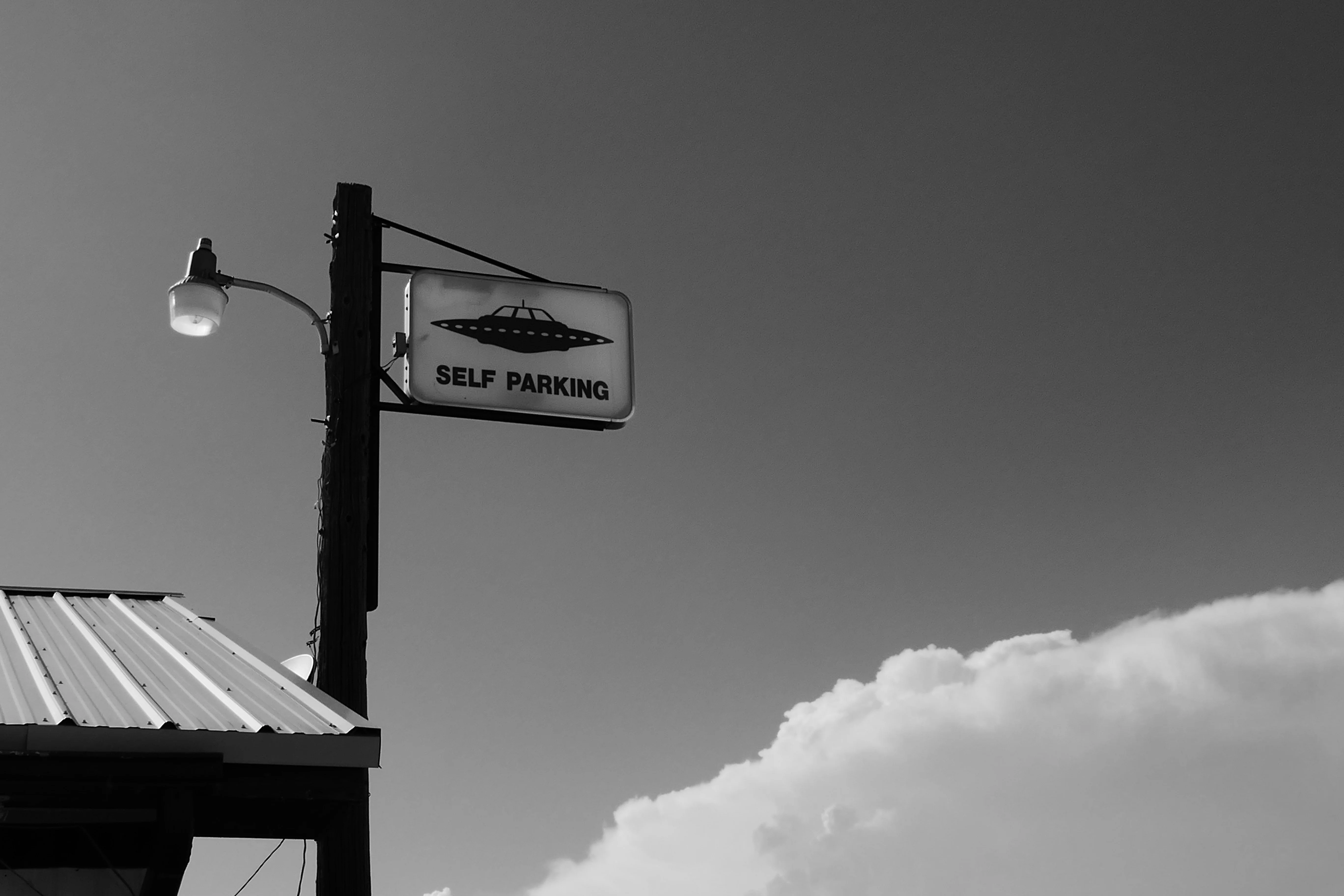 Sign for self-parking with UFO design against a clear sky