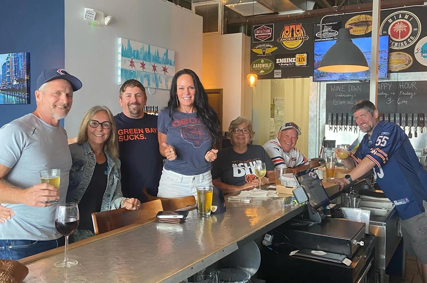 Group of friends enjoying drinks at a lively bar