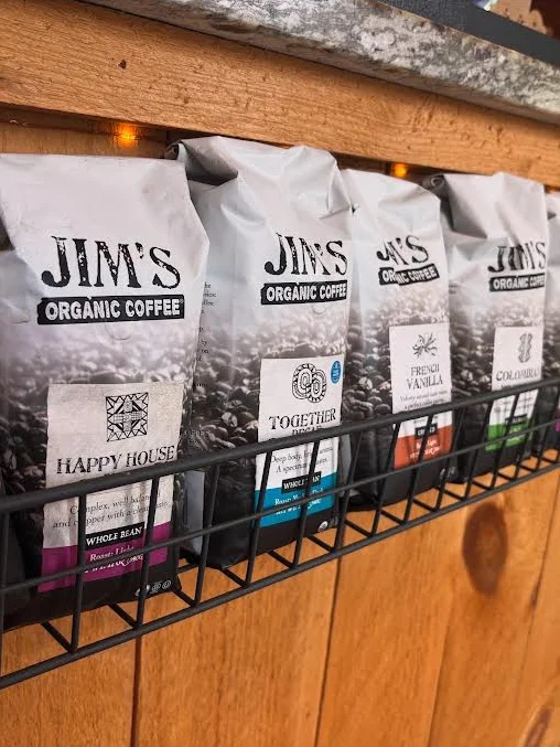 Variety of organic coffee bags displayed in a rustic setting