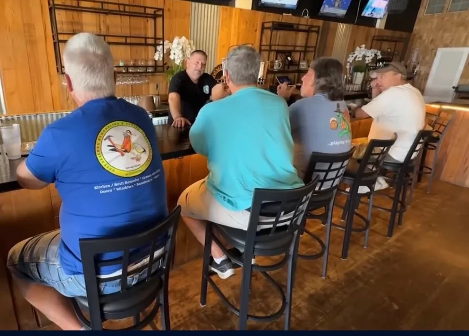 Lively bar scene with patrons enjoying drinks and conversation