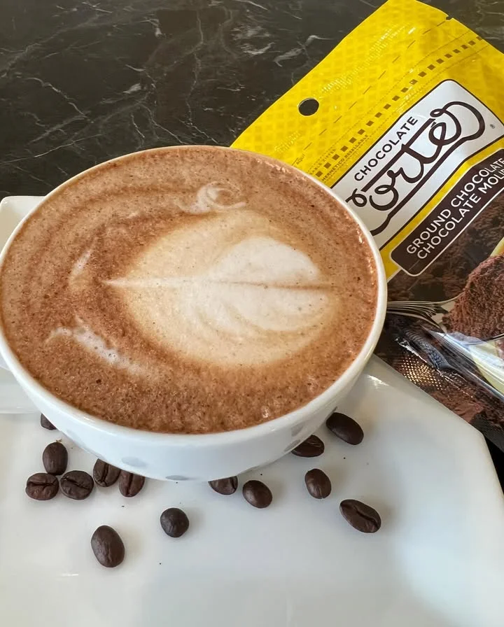 Rich chocolate latte art in a cozy café setting