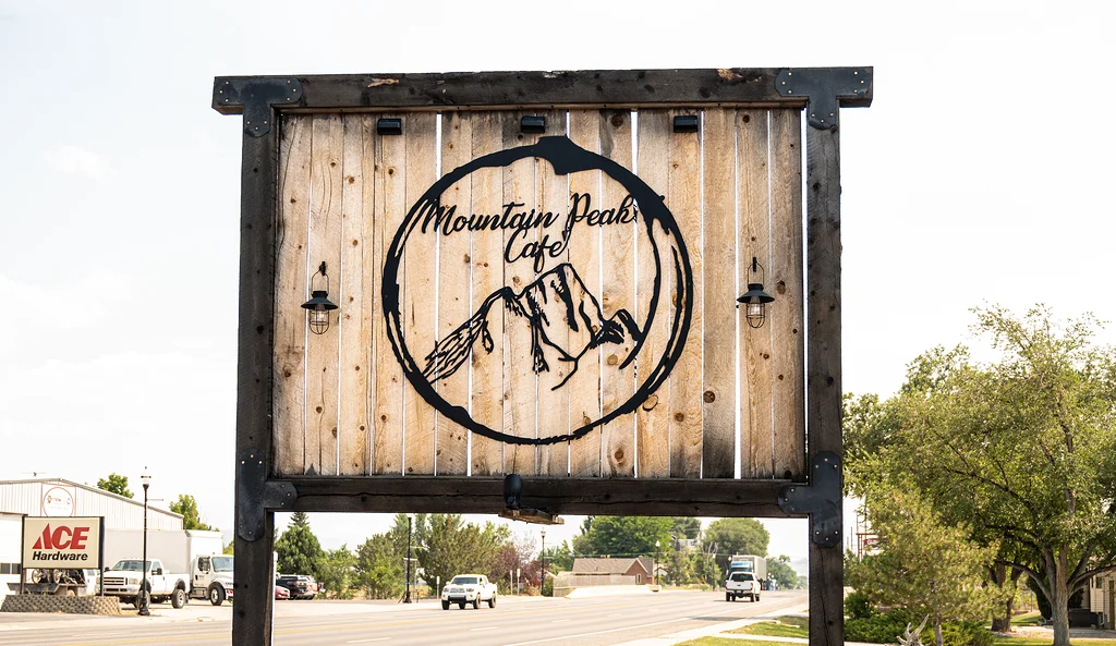 Mountain Peak Cafe sign with rustic wooden design