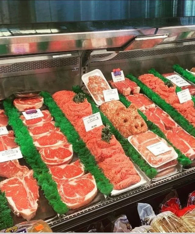 Assorted cuts of beef in a butcher display case