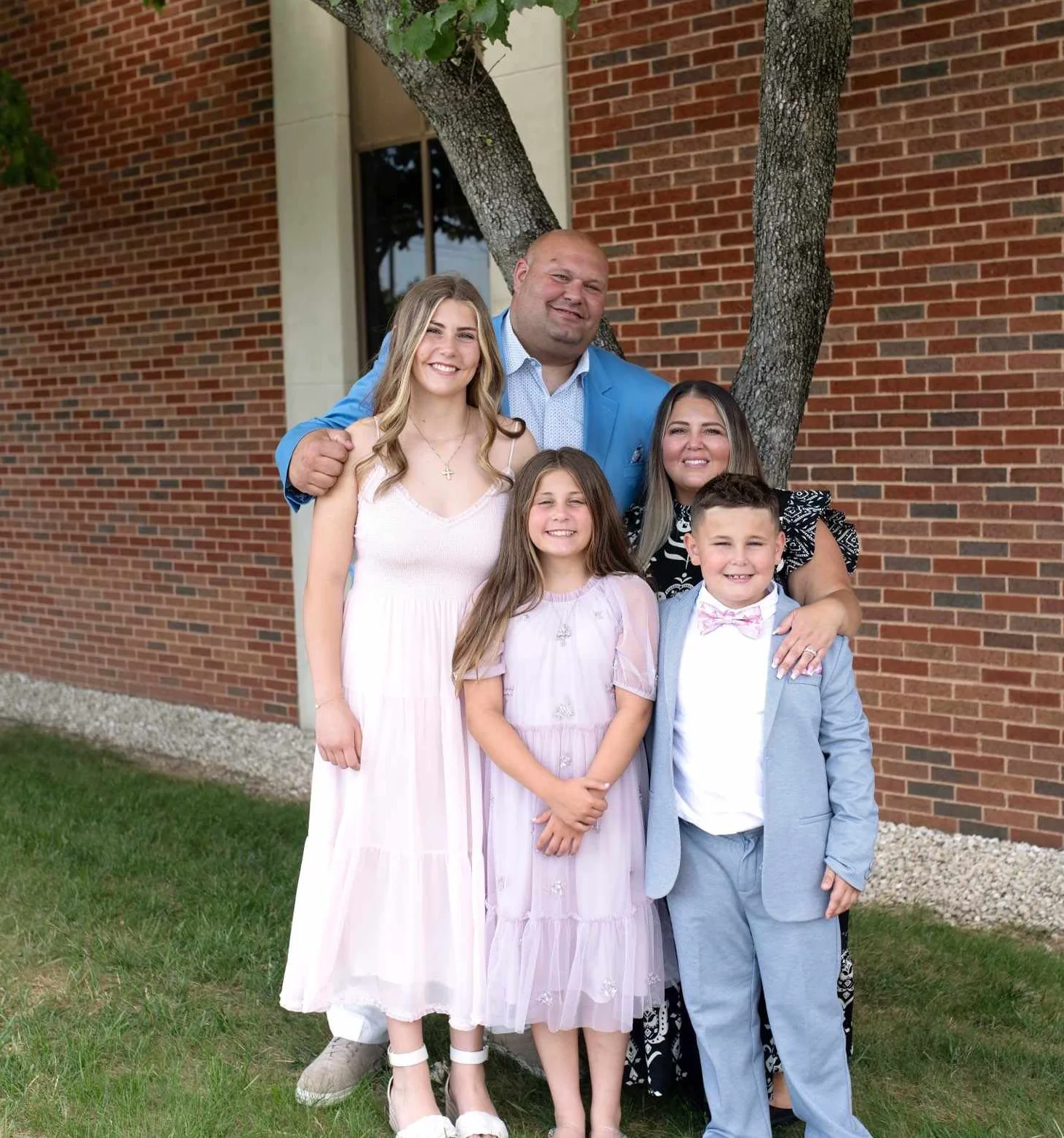 Family portrait outdoors with children and adults smiling together