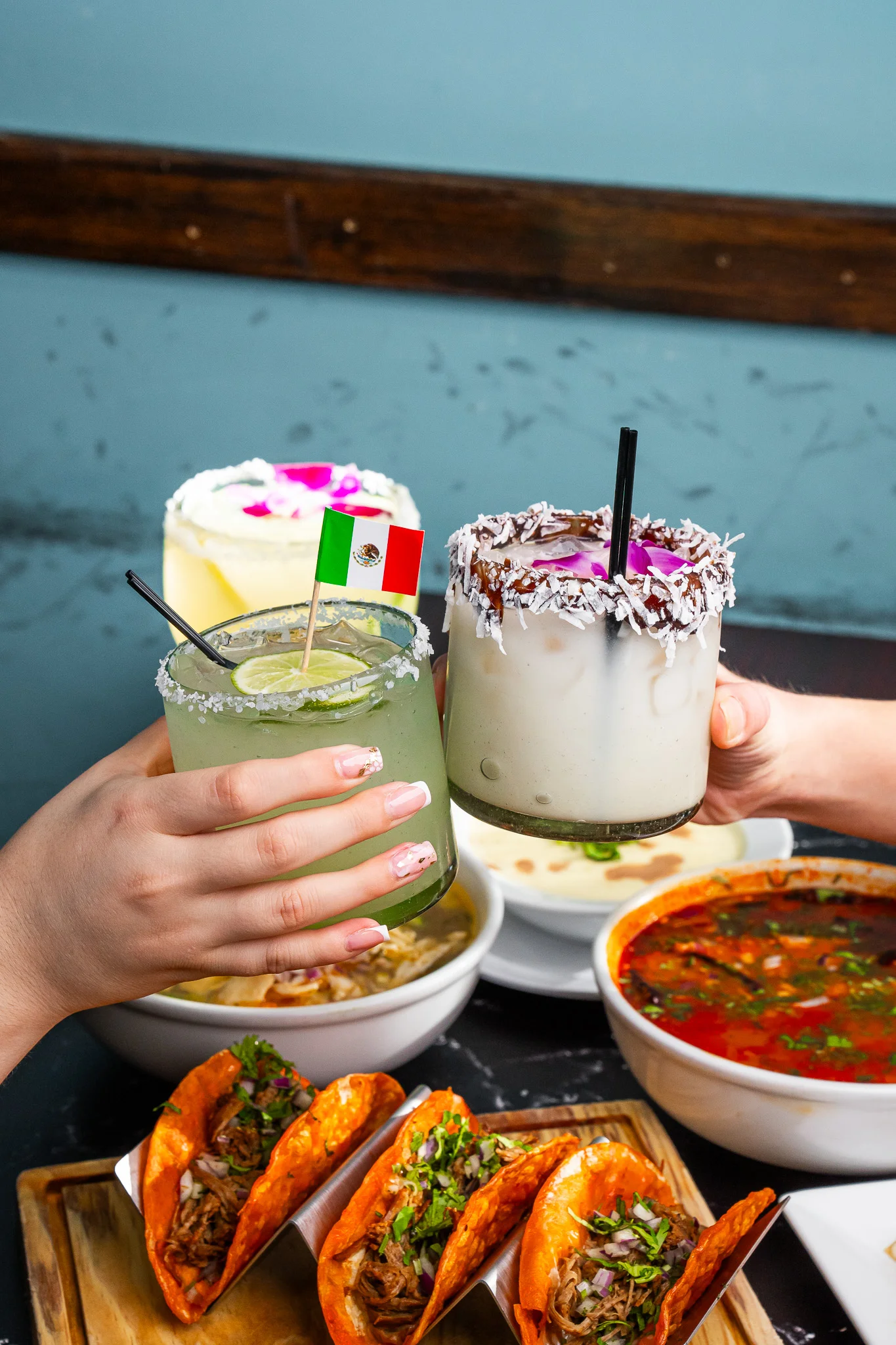 Colorful cocktails and tacos in a vibrant Mexican restaurant setting
