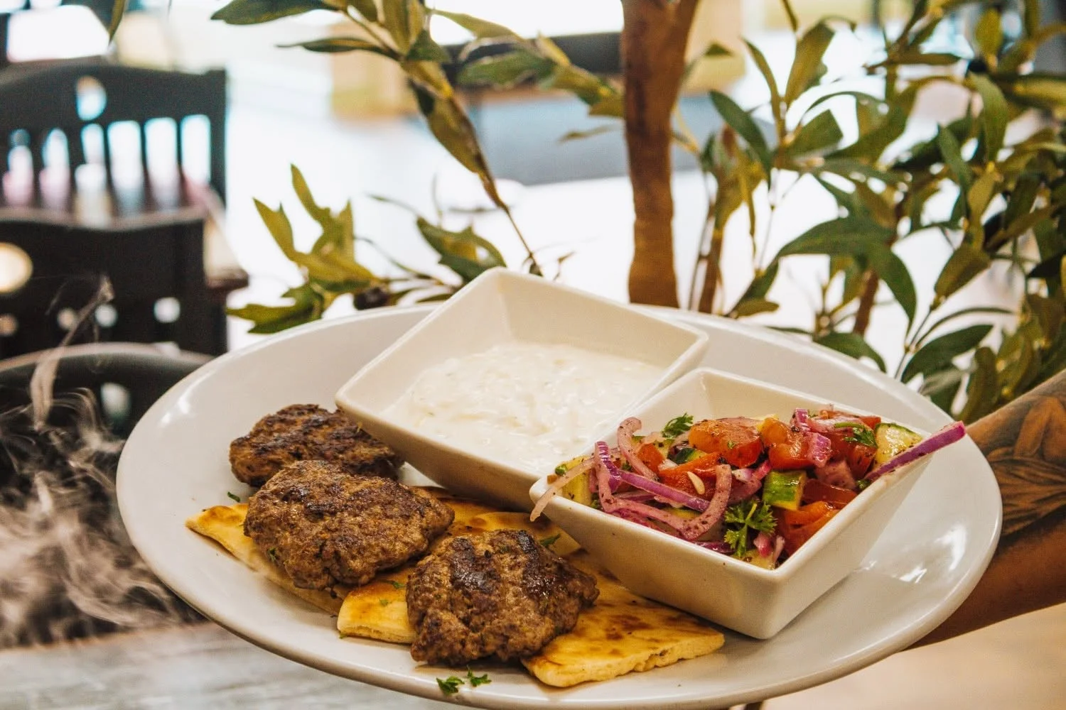 Mediterranean kofta platter with yogurt and salad