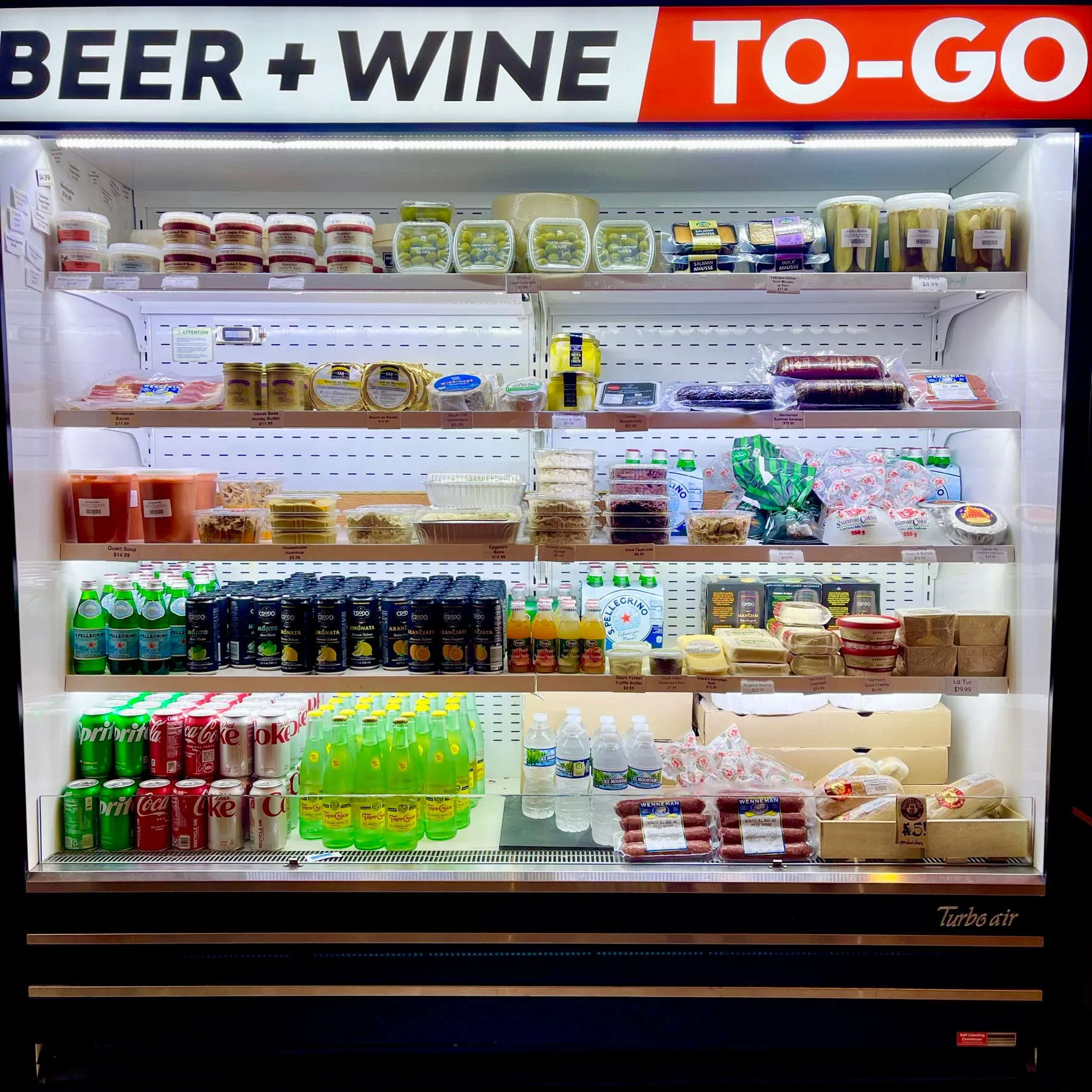 The grab 'n' go grocery cooler, full of soups, dips, spreads, sandwiches, olives, cheeses, pickles, beverages, cool and ready to go!