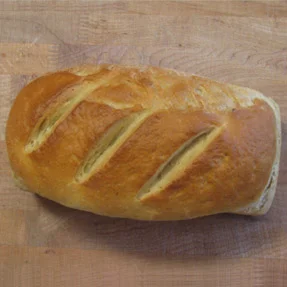 Freshly baked Italian ciabatta loaf on a wooden surface
