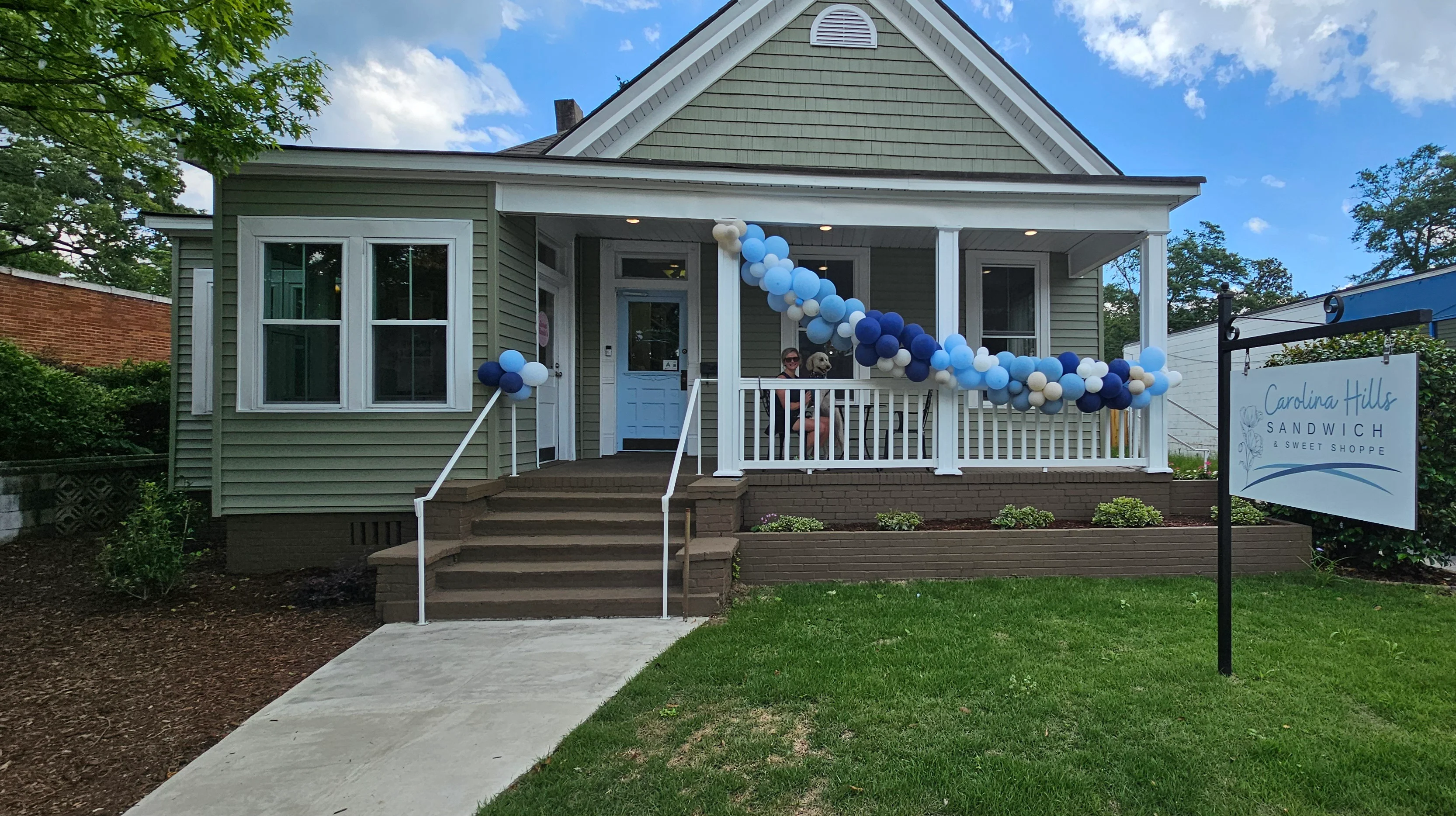Charming sandwich shop exterior with festive balloons