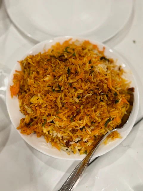 Indian biryani served on a white plate with fragrant spiced rice