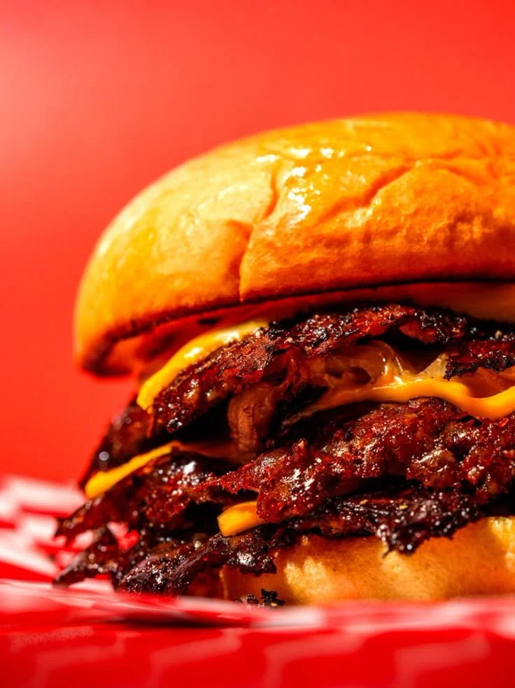 Delicious gourmet burger with fresh toppings on a wooden table