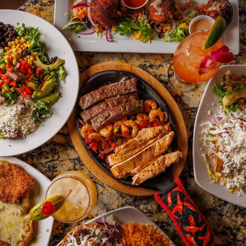 Sizzling fajitas platter with grilled meats and shrimp