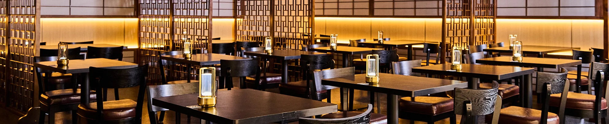 Elegant restaurant interior with warm lighting and wooden decor