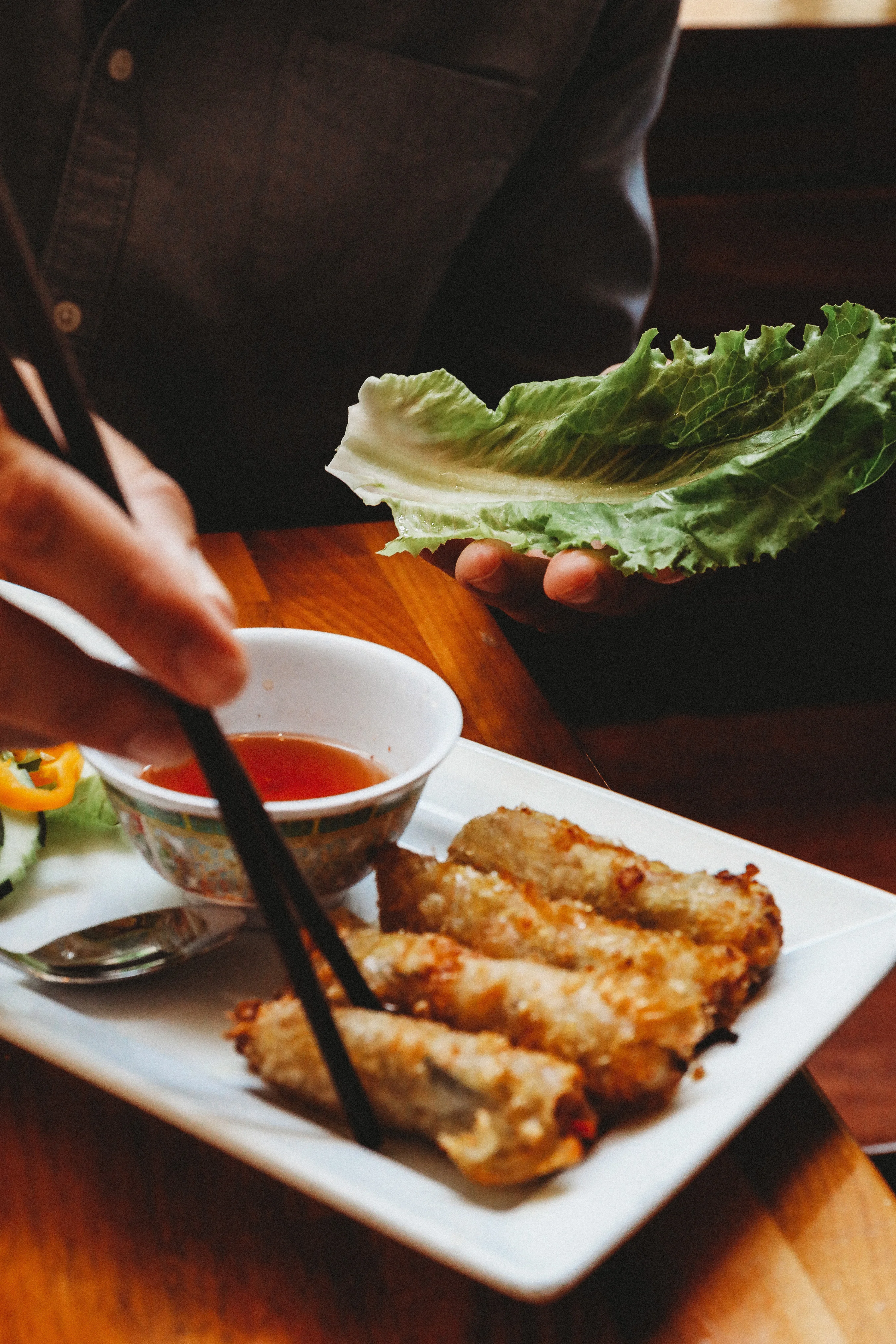 Vietnamese spring rolls with dipping sauce and fresh lettuce