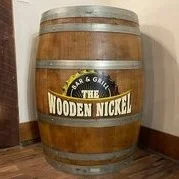 Wooden barrel with logo of The Wooden Nickel Bar & Grill
