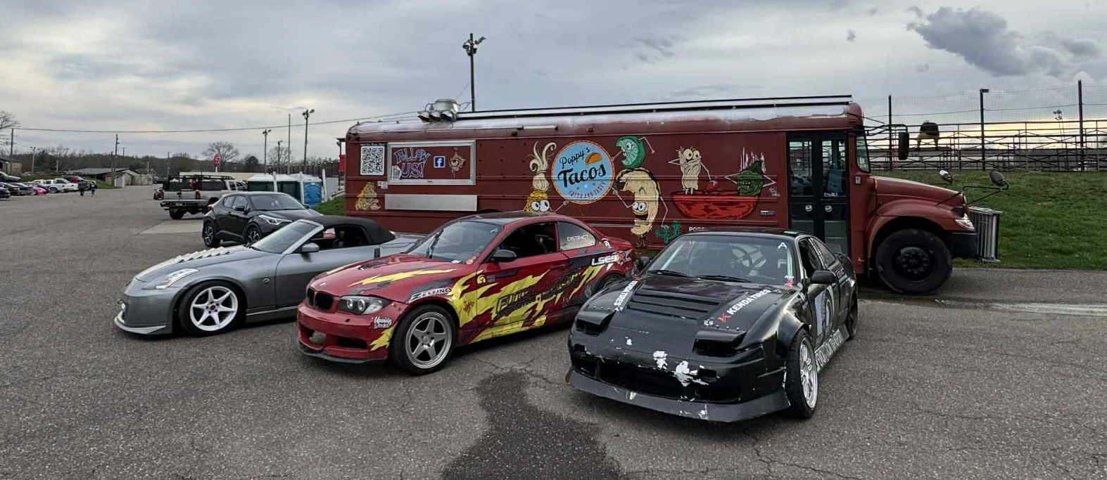 Food truck serving tacos at a car meet with modified vehicles