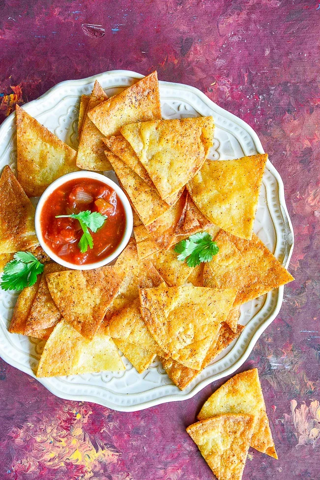 Crispy tortilla chips with salsa and cilantro